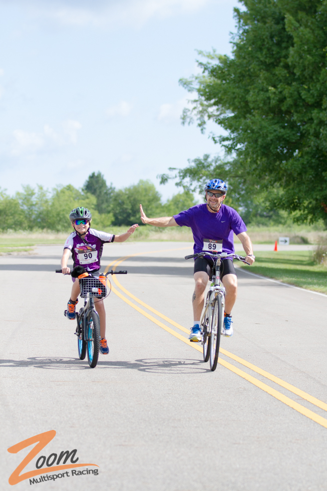 Father and Son Giving High Five While Biking